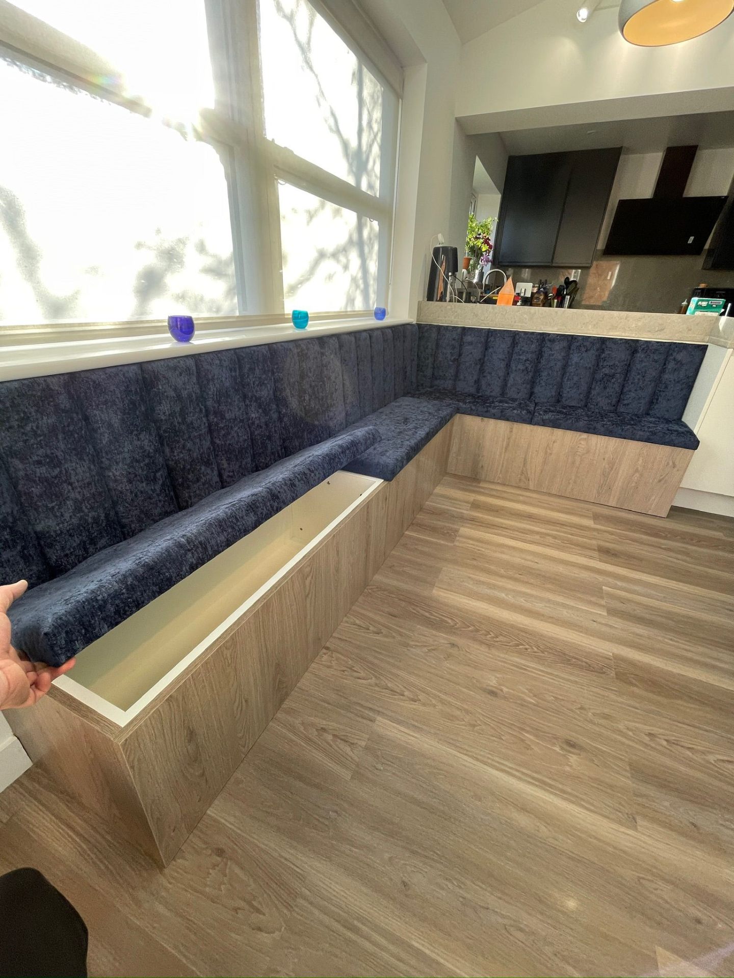 Banquette bench with lift-up seat showing hidden storage compartment