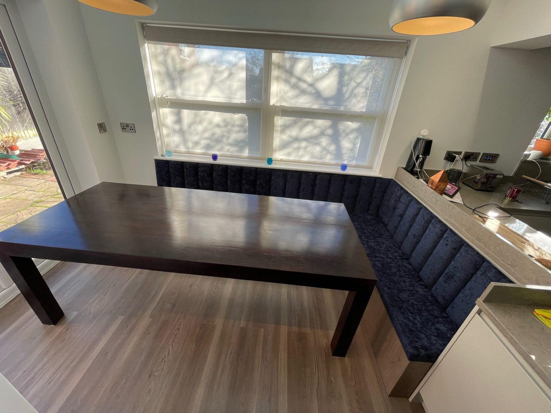 Bespoke banquette seating with dark wood dining table