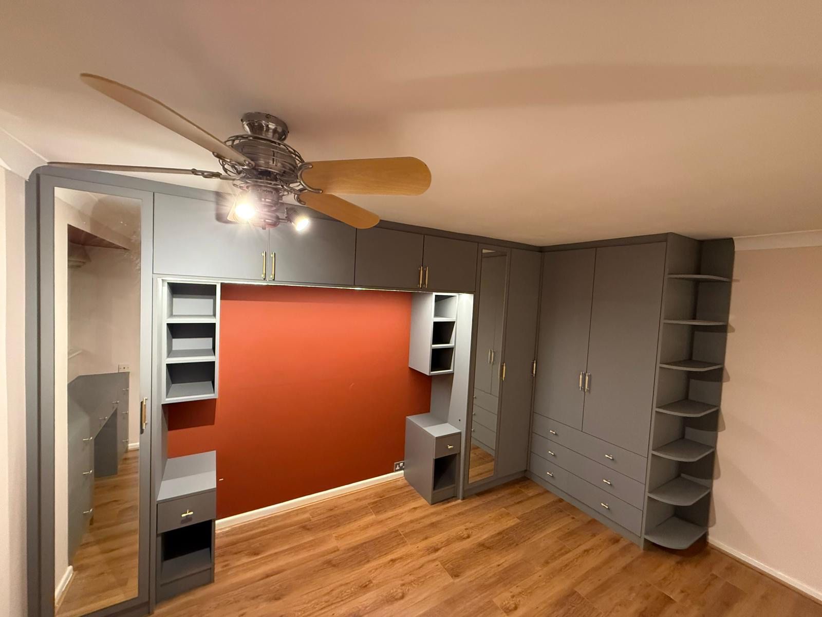 Grey overbed storage unit with integrated wardrobe and bedside cabinets