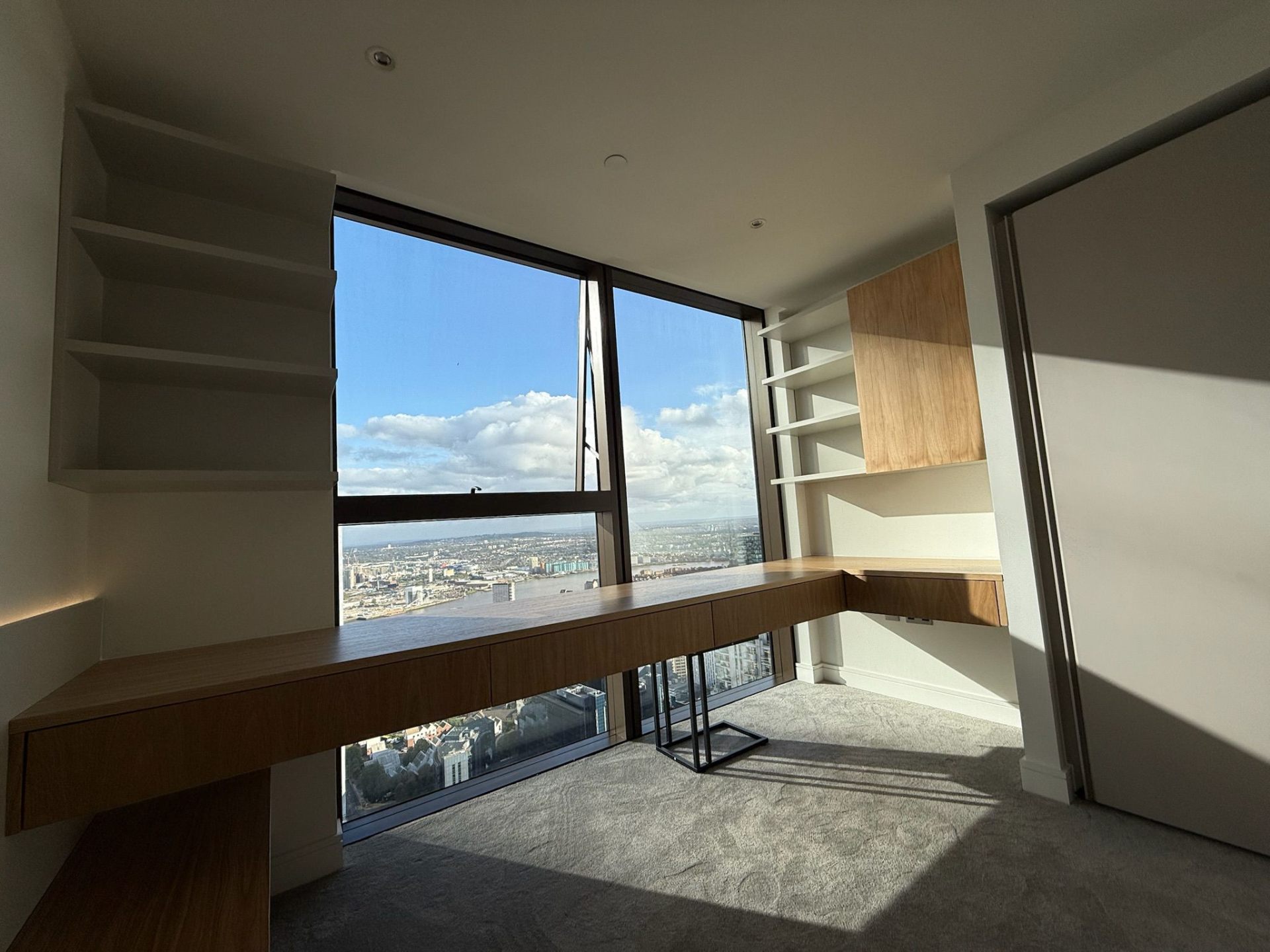 Built-in desk with city views in a modern apartment home office