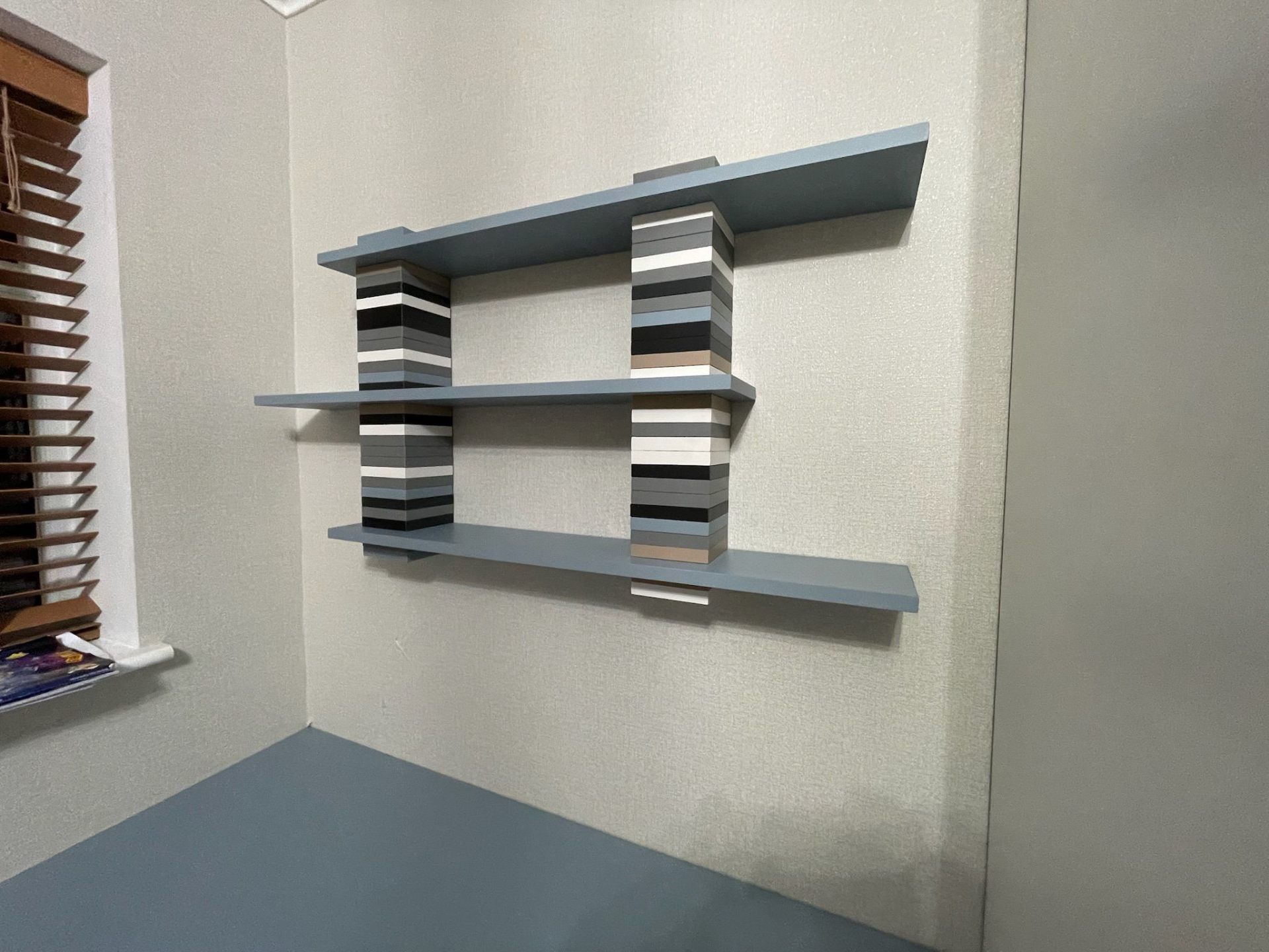 Floating shelves on a blue wall