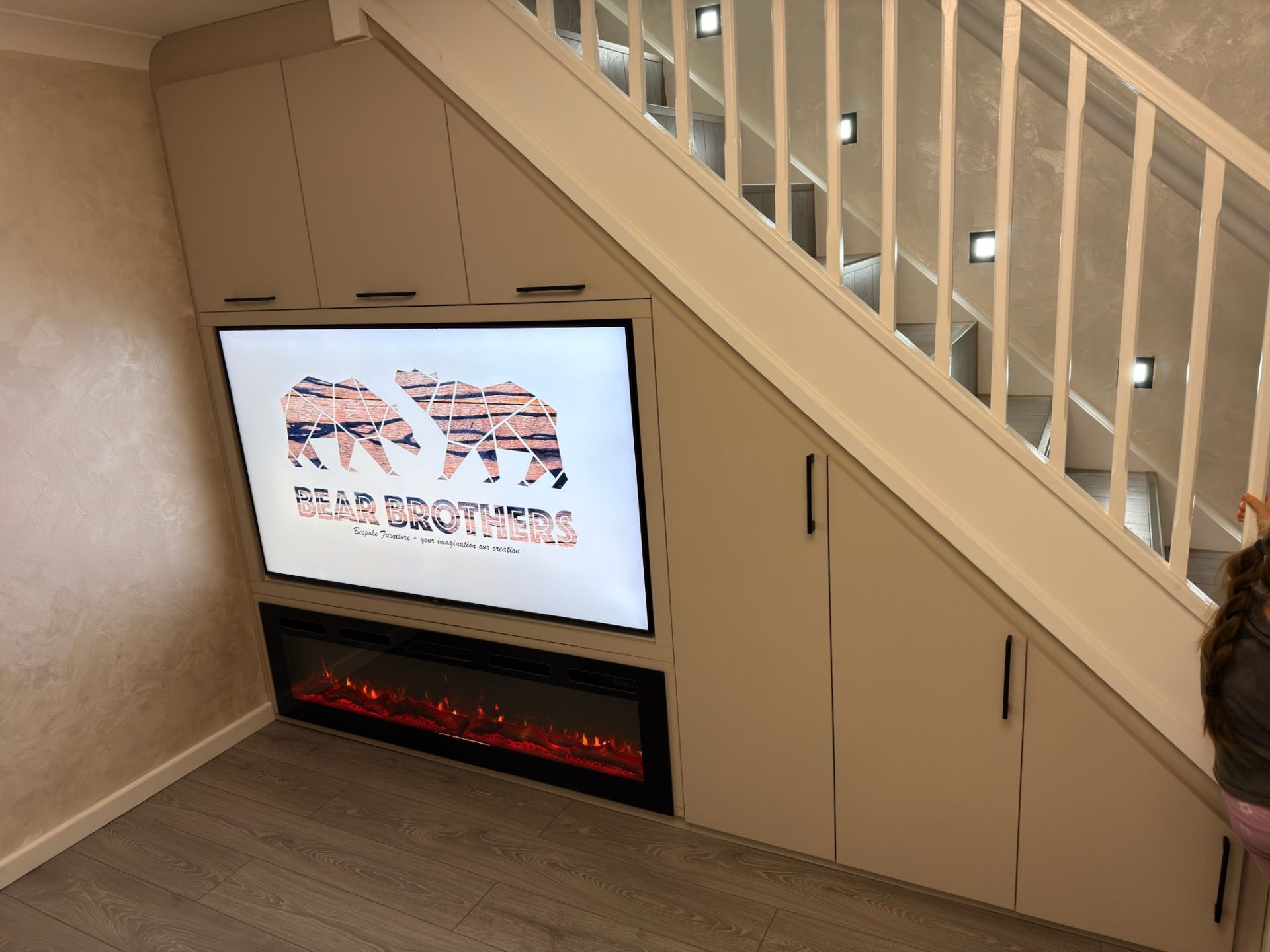 Under-stairs storage with integrated TV unit and pull-out drawers