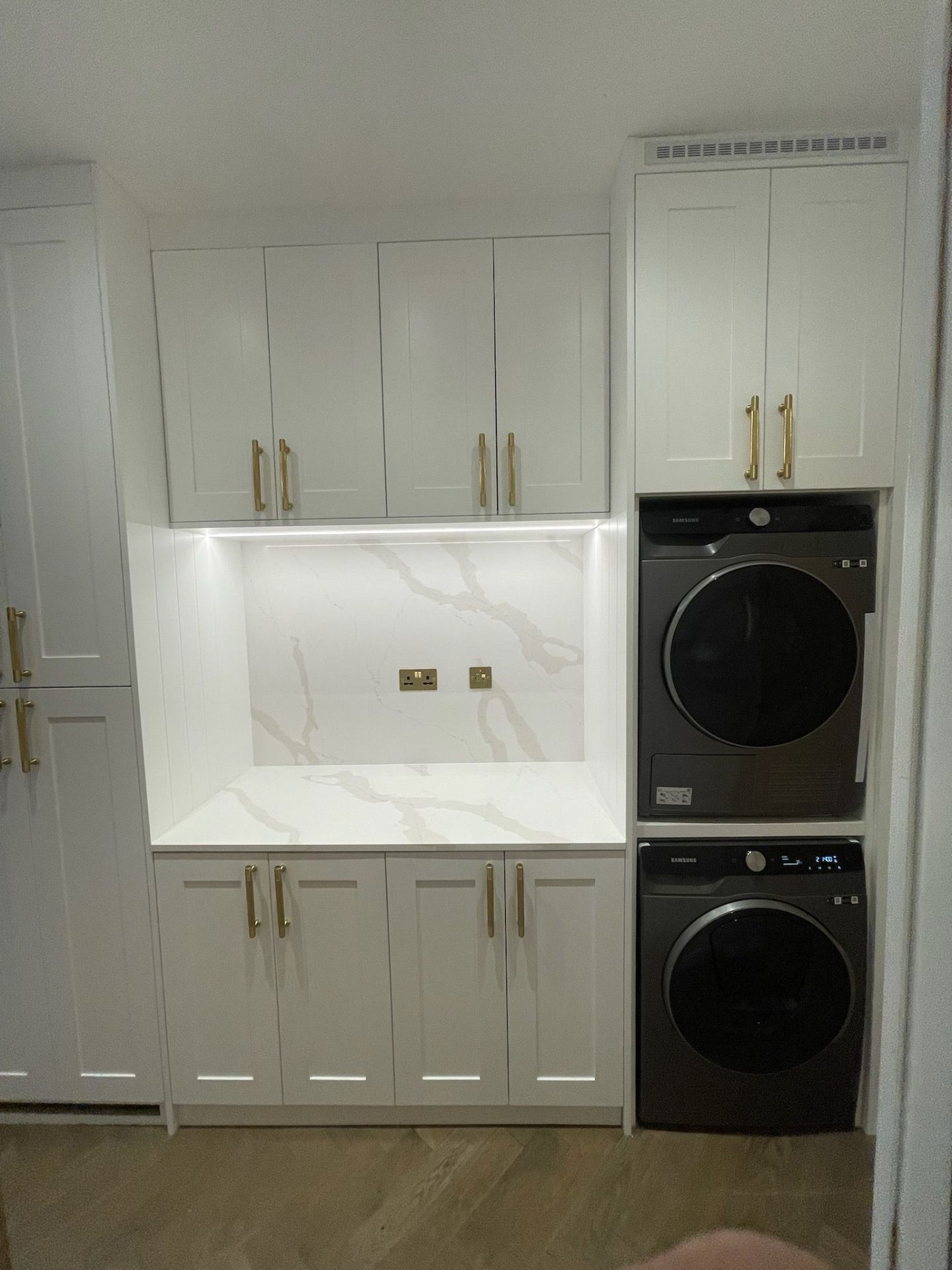 White utility room cabinets with worktop and overhead storage