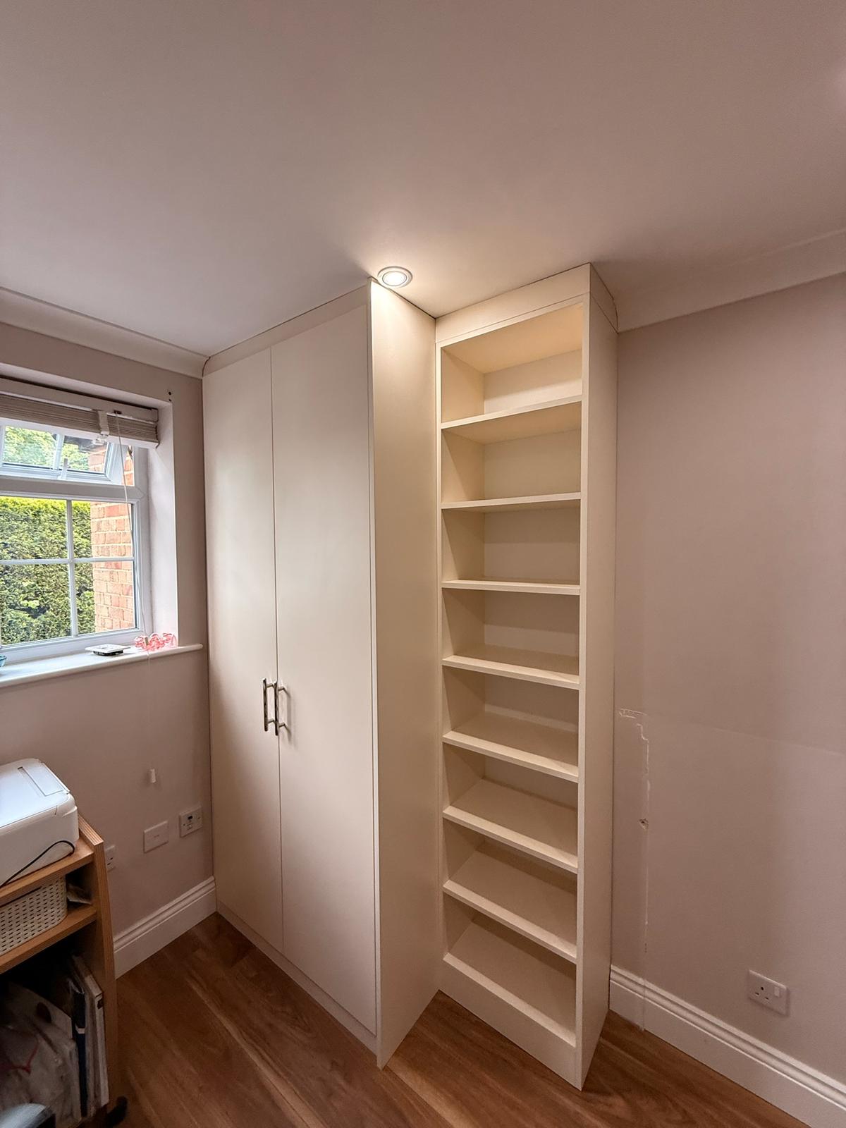 Corner wardrobe with adjacent floor-to-ceiling shelving unit