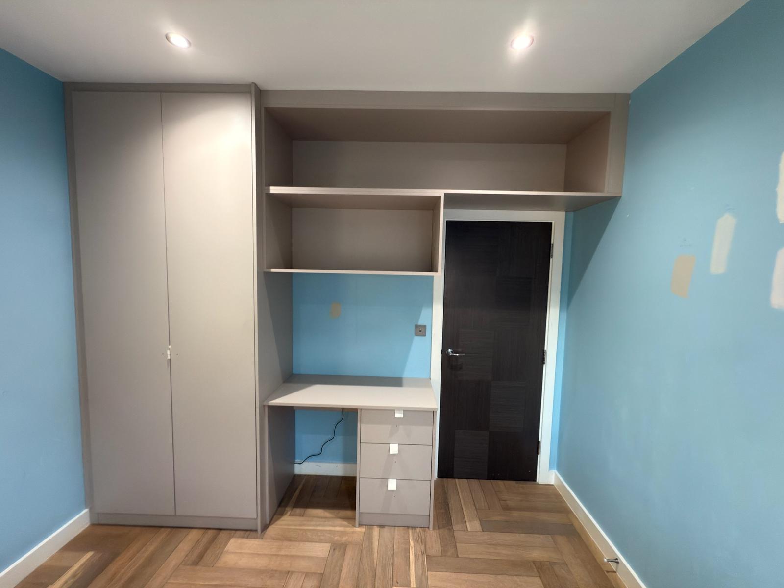Fitted wardrobe with integrated desk and drawers