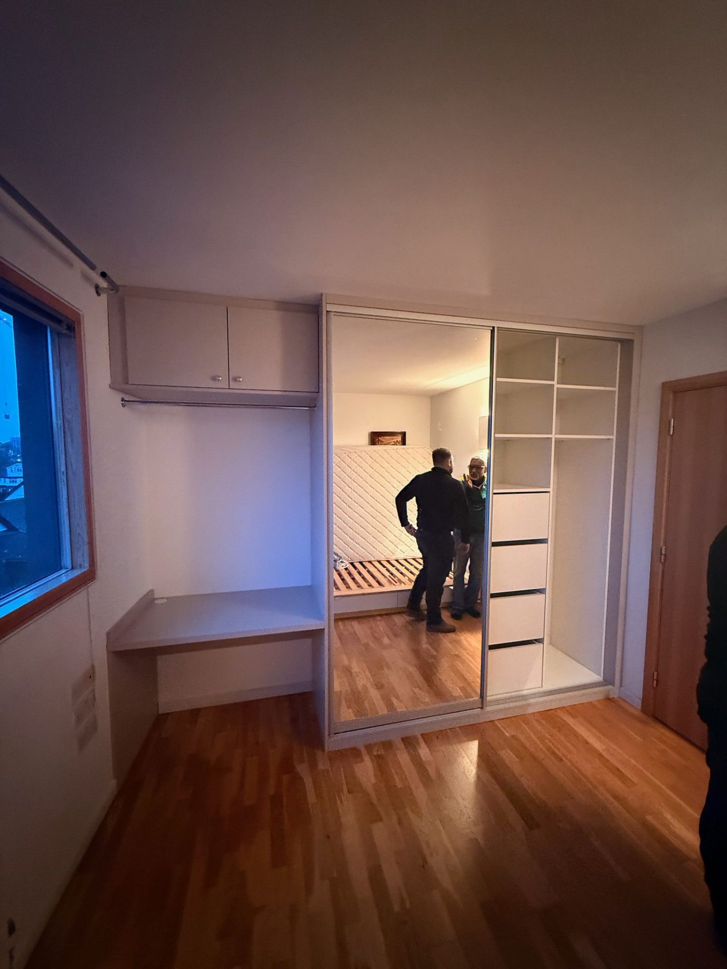 Fitted wardrobe system with desk, mirror doors and internal shelving
