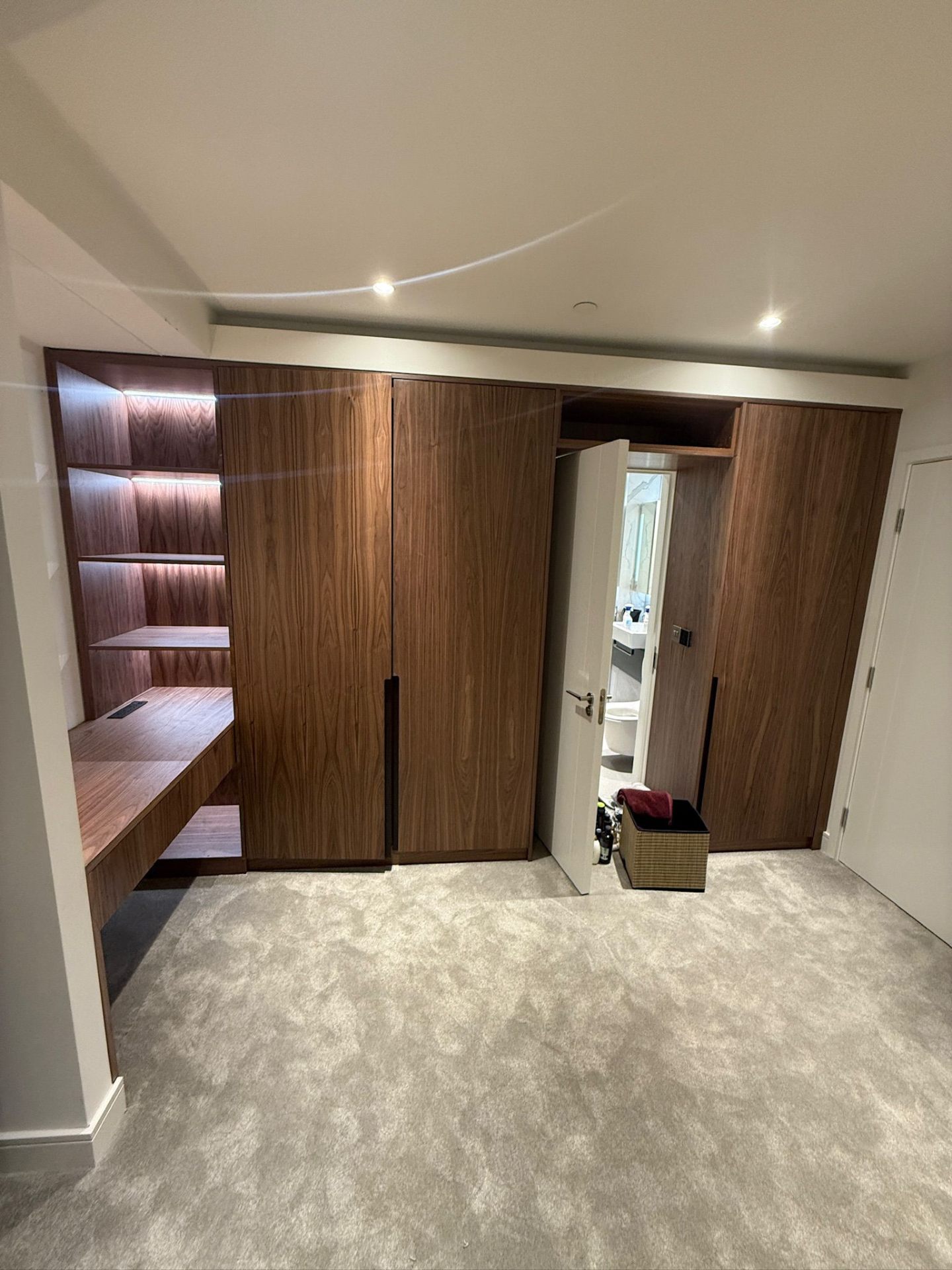 Fitted wardrobe in walnut finish with LED strip lighting detail
