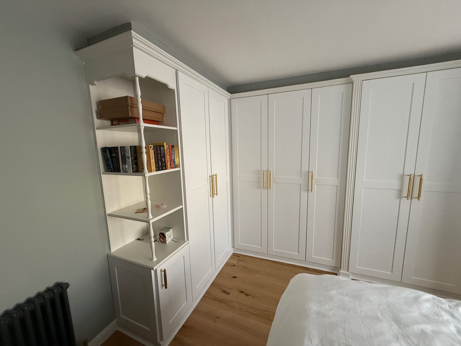 White corner fitted wardrobe maximising bedroom space